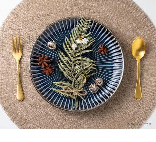 A navy color SENDAN plate in a table setting showing the beauty of this series' tableware