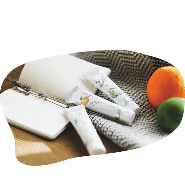 Hand cream with calming botanical ingredients, styled with essential oil elements