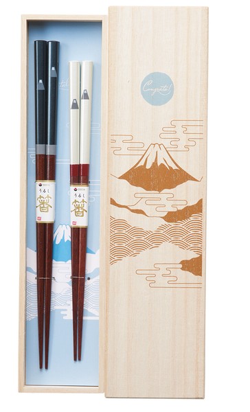A set of chopsticks with Mount Fuji design, presented in a wooden box with a graphic of the mountain.