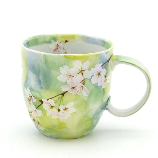 Fresh green cherry blossom mug with lifelike sakura pattern on smooth porcelain