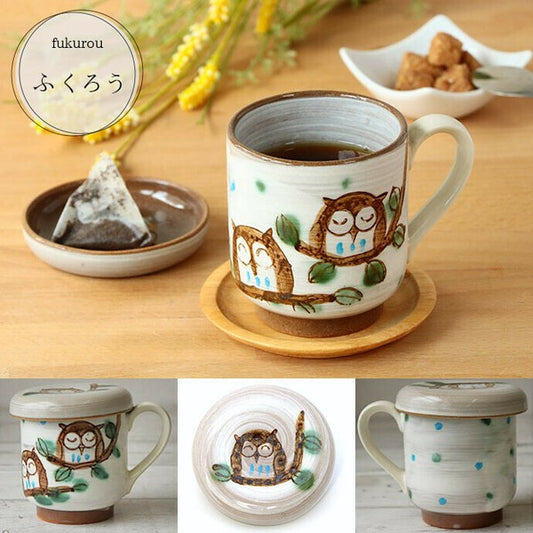 Detailed view of owl illustration on Japanese ceramic mug and used teabag put on the lid.