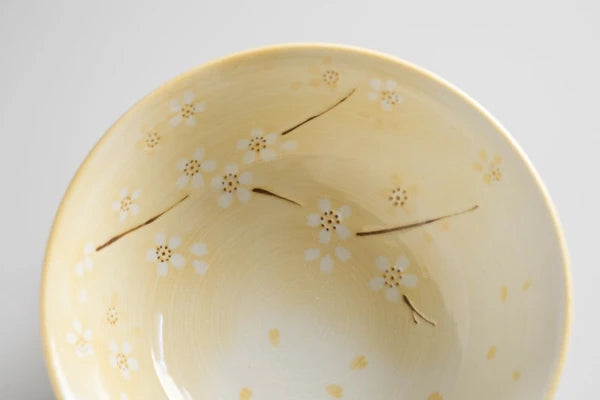 Close view of yellow hanamai rice bowl with cherry blossom pattern