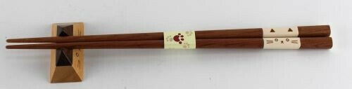 air of wooden chopsticks with matching cat-eared rests displayed together