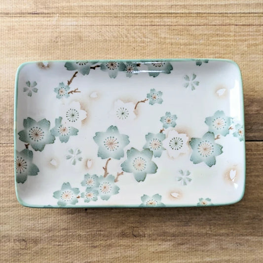 Close-up of textured water-repellent sakura motif on glossy porcelain plate