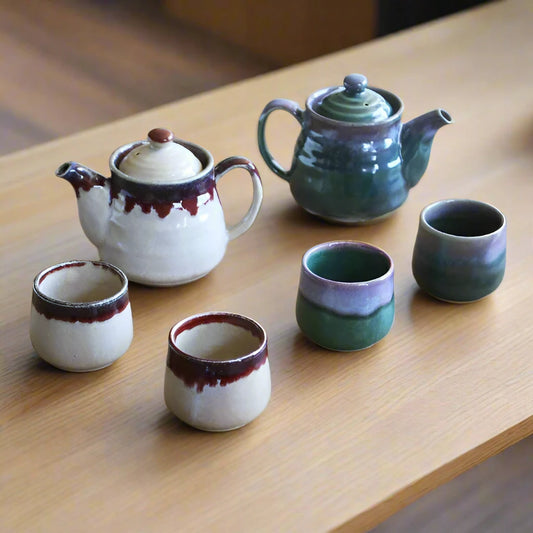 Minoware Shinsha teapot sets in both Unofu (beige) and Ryokuyu (green) glaze, each including a teapot and two cups, displayed side by side