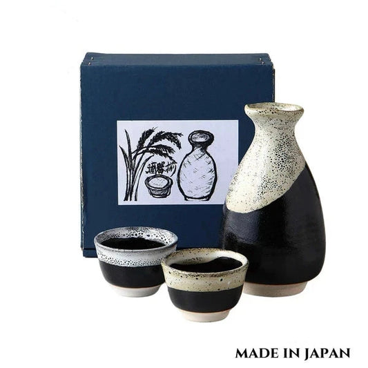Midnight Glow sake set in dark glaze with subtle shimmering highlights and clean silhouette displayed in front of its packaging box