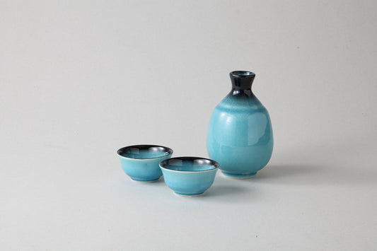 Glossy Mino ware sake set in vibrant Turkish blue glaze, with rounded carafe and two cups