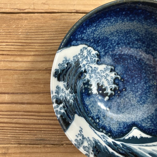 Close-up of Great Wave interior on ceramic bowl, vibrant blue crest and detailed porcelain glaze