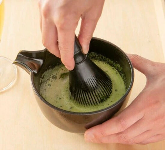 Shifuku set in use, whisking matcha tea in spouted bowl