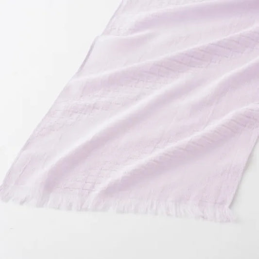 Close-up of the delicate gauze and textured weave of the Shikisai muffler, highlighting the diagonal igeta pattern