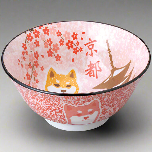 A ceramic bowl with a Shiba Inu dog and cherry blossom design, featuring Kyoto landmarks.