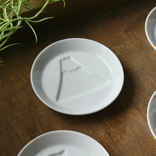 White porcelain dipping plate with sauce revealing a Mount Fuji design, Japanese made mini plate