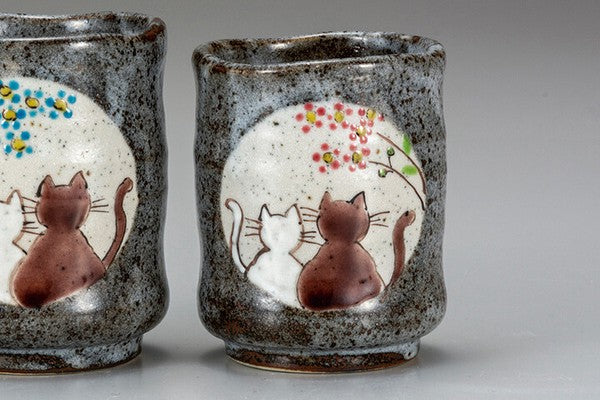Close-up detail of Kutani Ware tea cup featuring adorable cats and colorful floral Kutani decoration