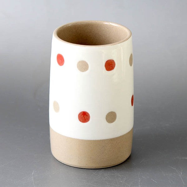 Arita ware polka dot utensil holder used for storing cutlery on a kitchen counter