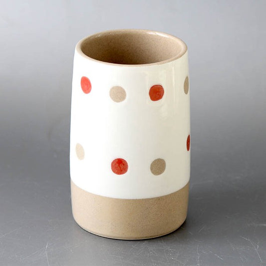 Arita ware polka dot utensil holder used for storing cutlery on a kitchen counter