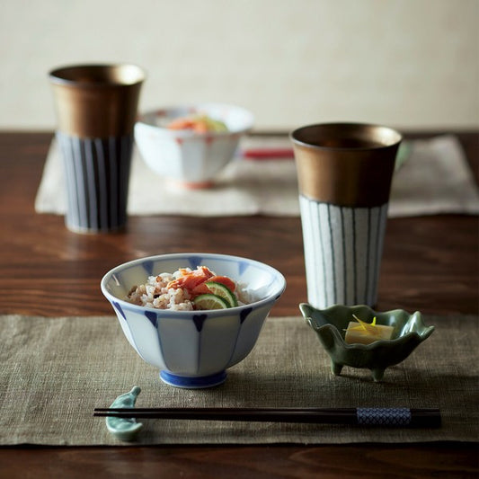 Mino ware Tokusa long cups placed on a dinner table setting, styled with dishes and chopsticks for an elegant Japanese dining scene.