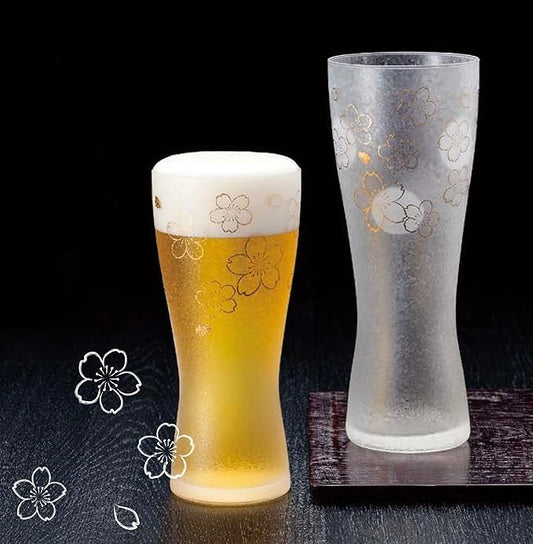 Sakura beer glass filled with golden beer and creamy foam