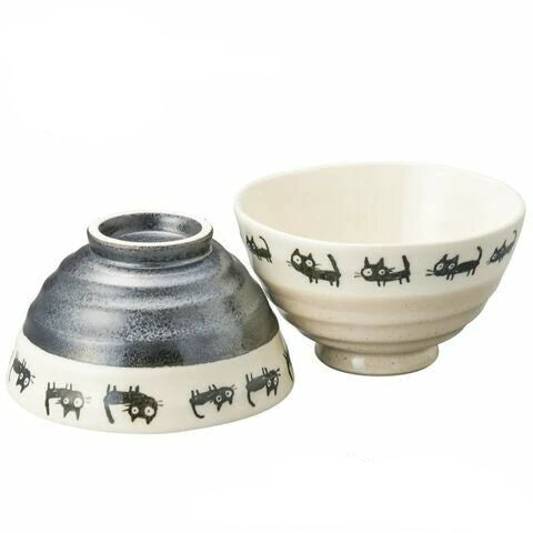 Pair of black cat-themed rice bowls made in Japan, featuring playful feline design