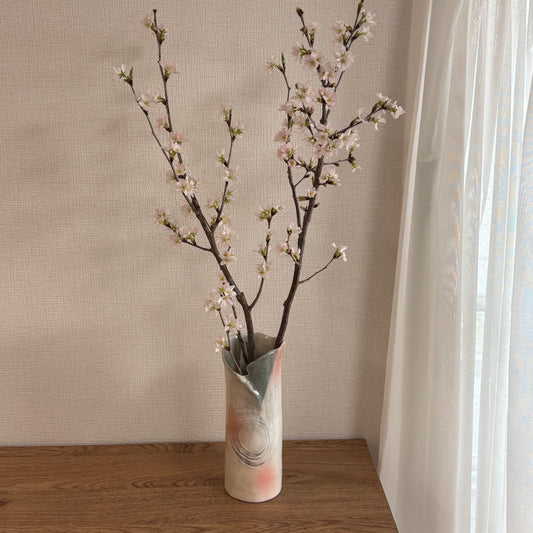 Japanese trumpet vase styled with cherry blossoms on wooden table