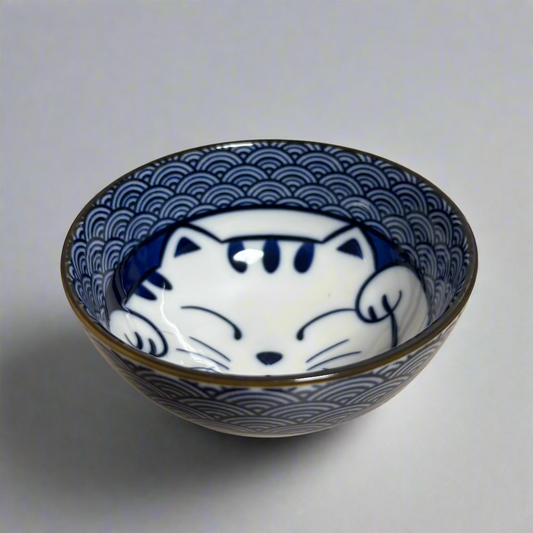Close-up of cat design on indigo blue Seigaiha patterned rice bowl