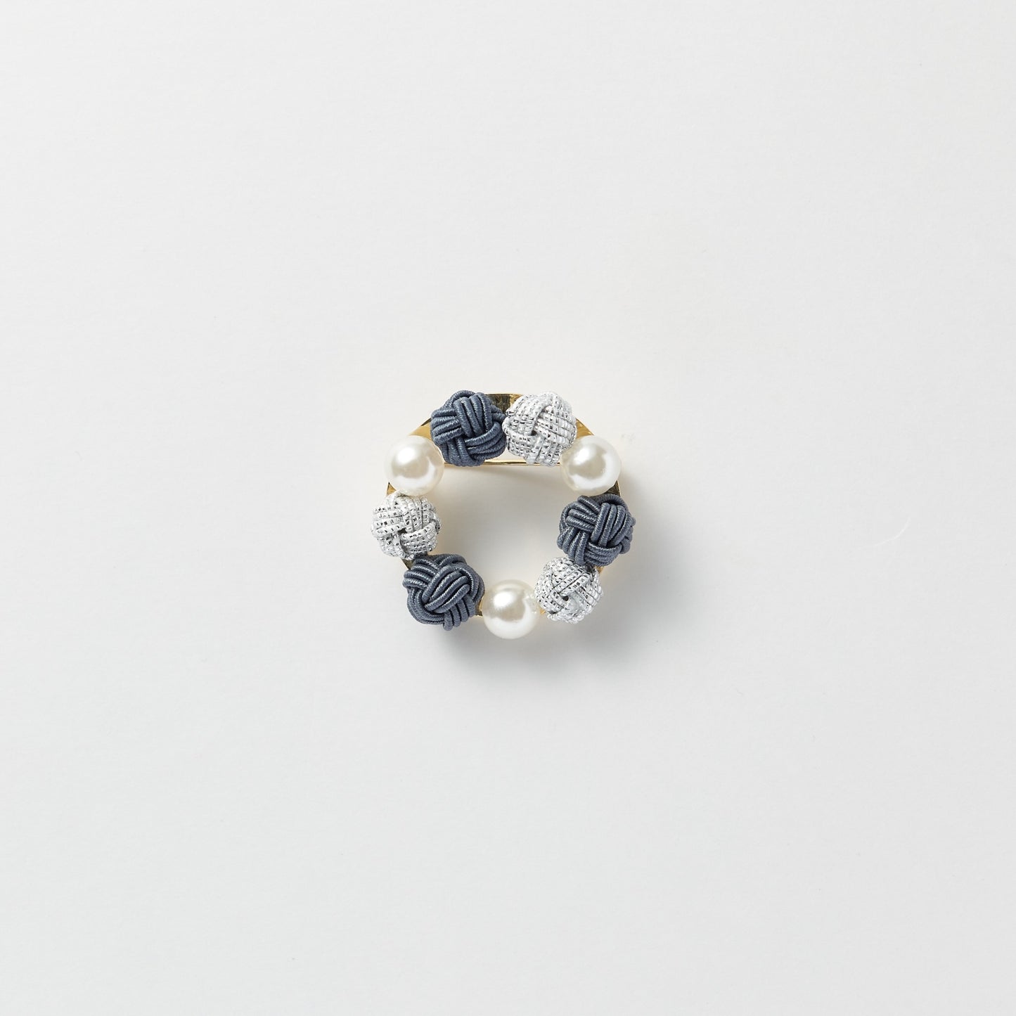 Elegant black pearl and mizuhiki brooch symbolizing connection and good wishes