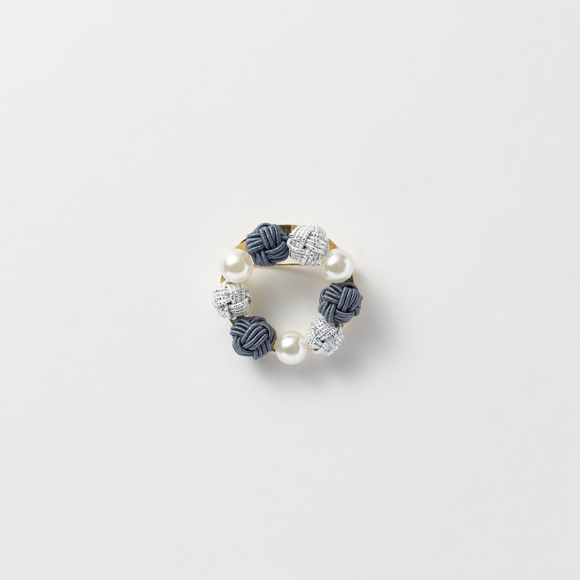 Elegant black pearl and mizuhiki brooch symbolizing connection and good wishes