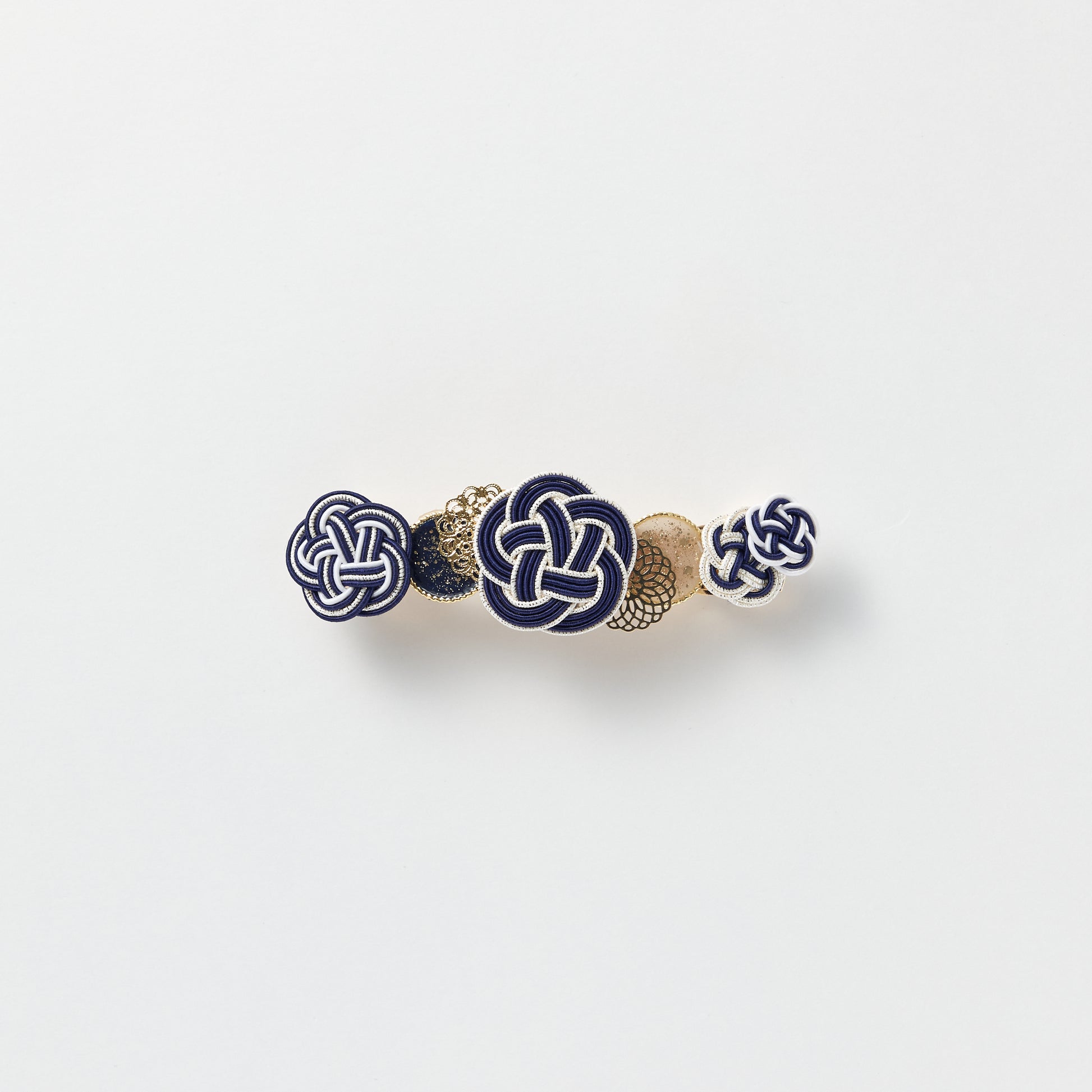 Front view of handmade Plum Blossom Knot Barrette in navy, featuring silk-wrapped mizuhiki knot