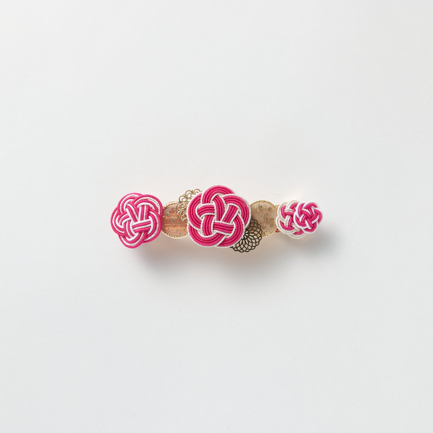 Front view of handmade Plum Blossom Knot Barrette in pink, featuring silk-wrapped mizuhiki knot
