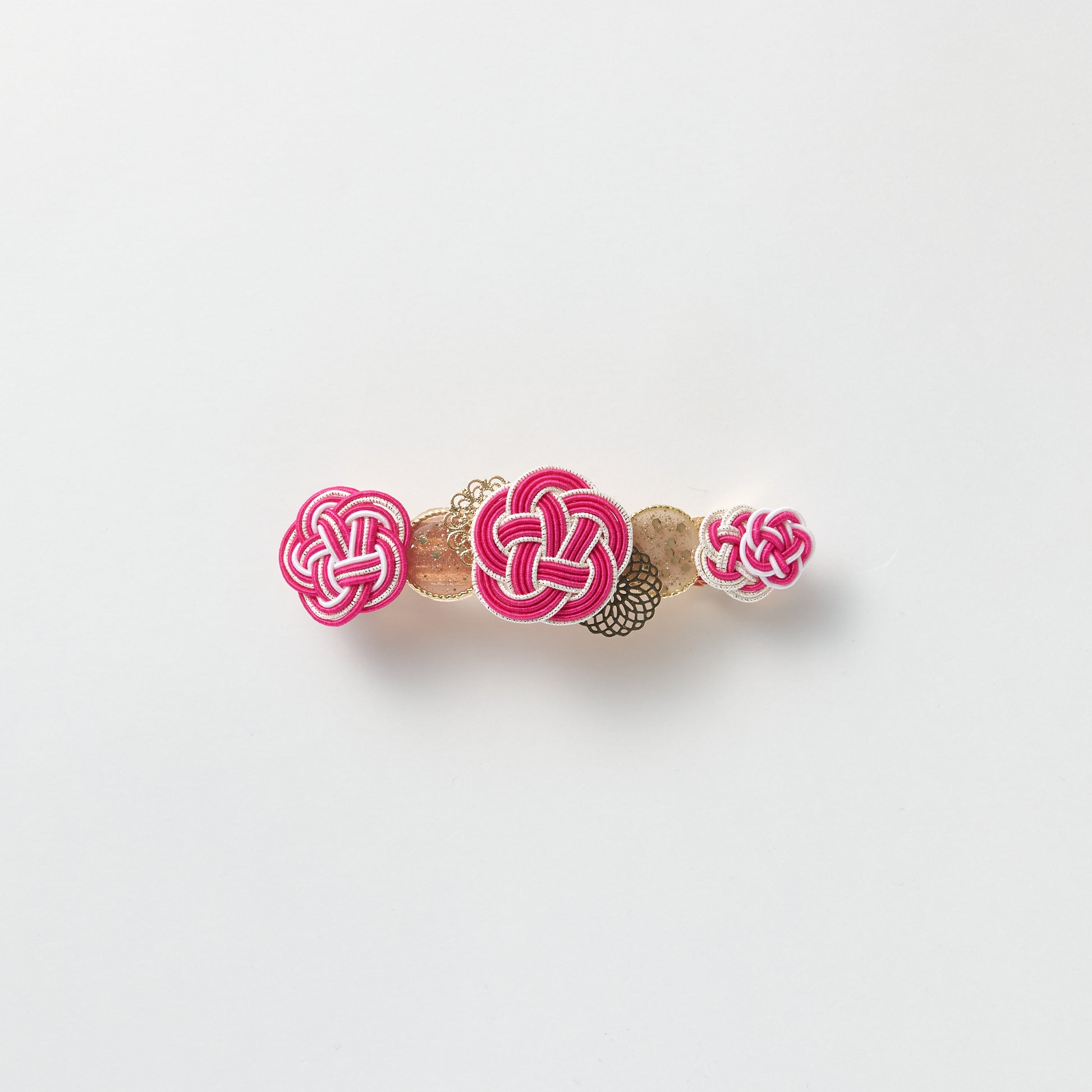 Front view of handmade Plum Blossom Knot Barrette in pink, featuring silk-wrapped mizuhiki knot