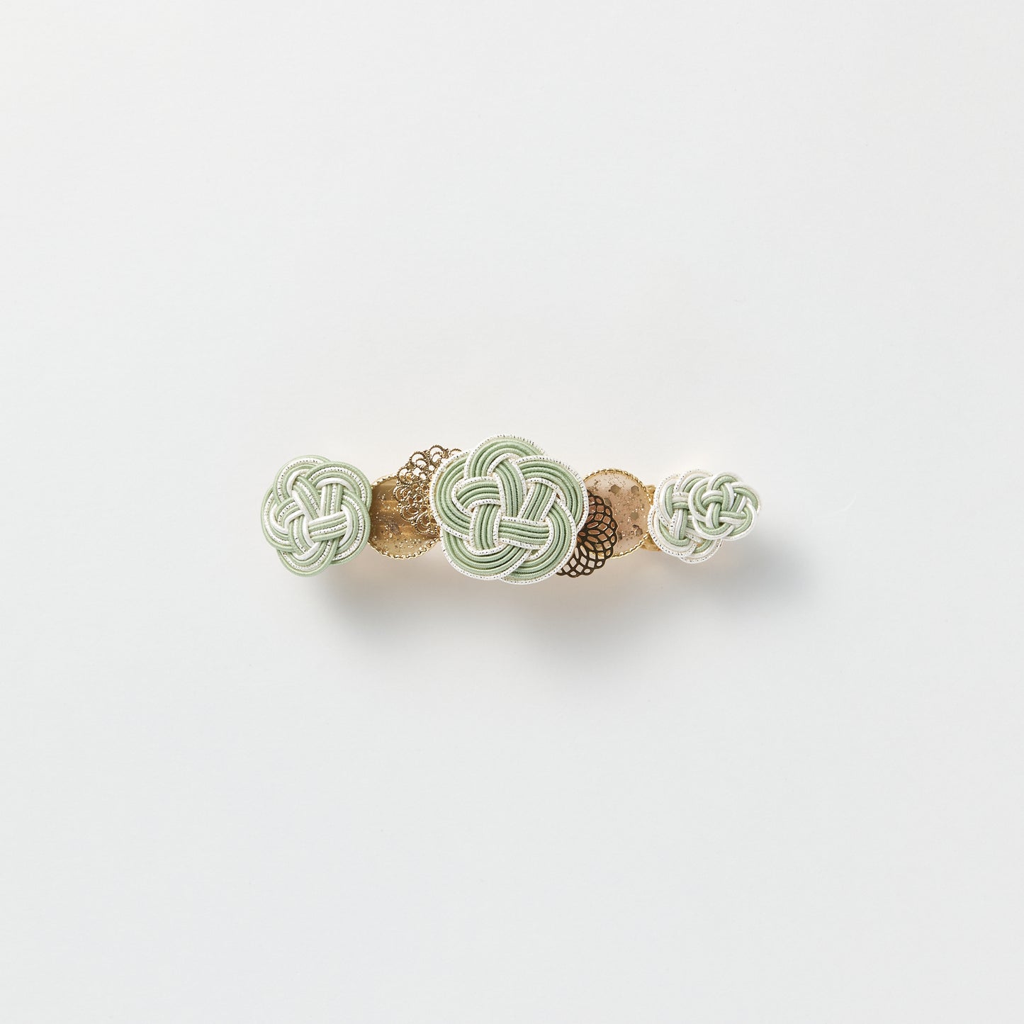 Front view of handmade Plum Blossom Knot Barrette in green, featuring silk-wrapped mizuhiki knot