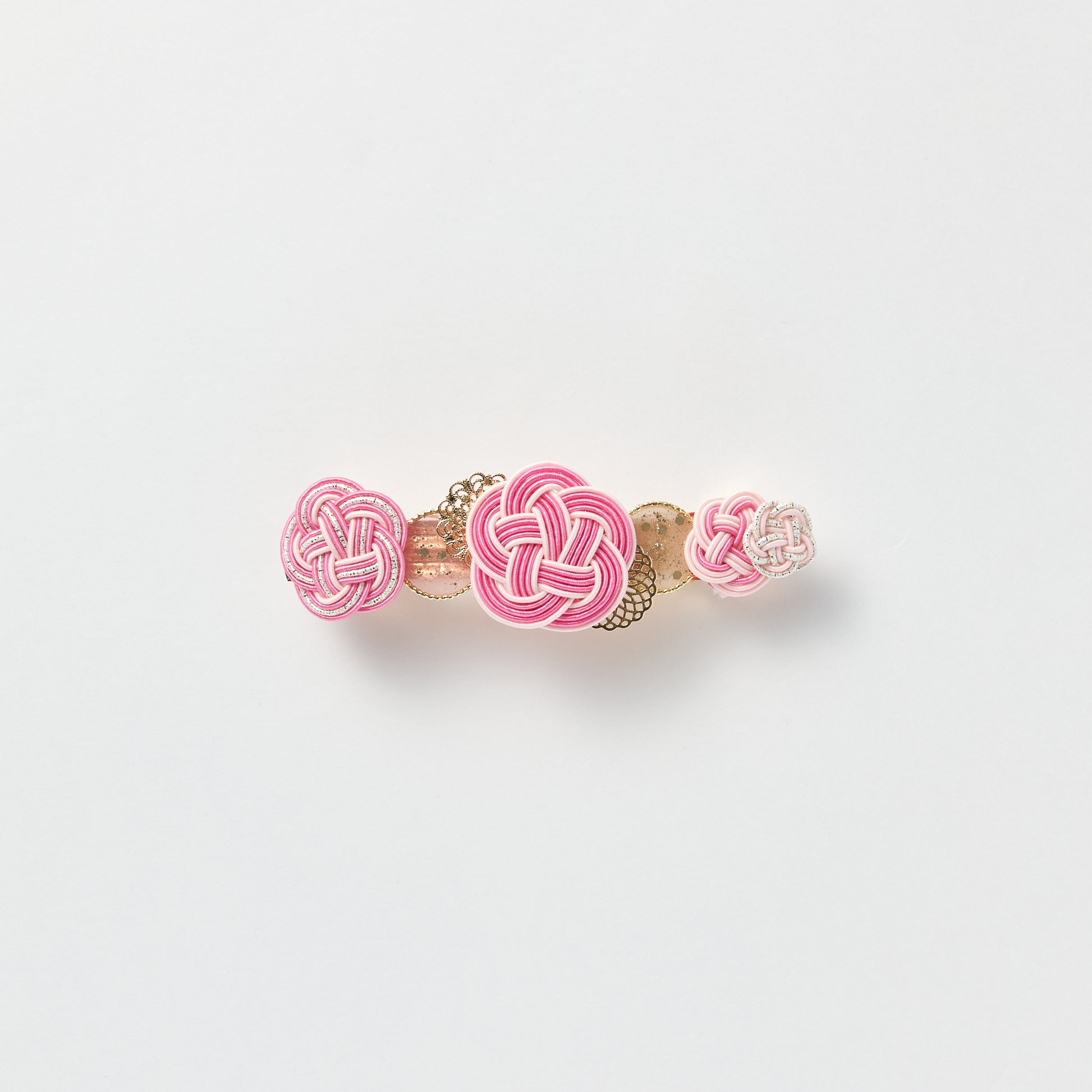 Front view of handmade Plum Blossom Knot Barrette in light pink, featuring silk-wrapped mizuhiki knot