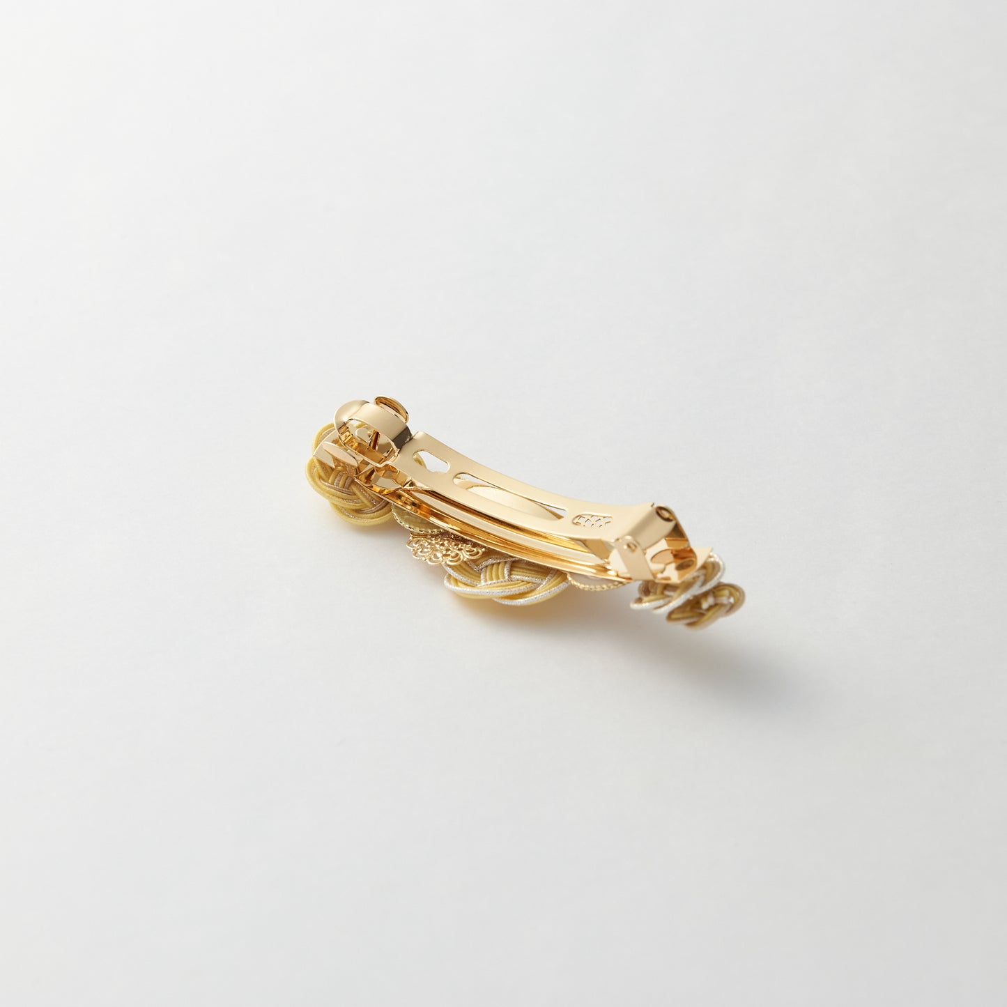Reverse side of handmade Japanese hair accessory in yellow, showing clasp detail