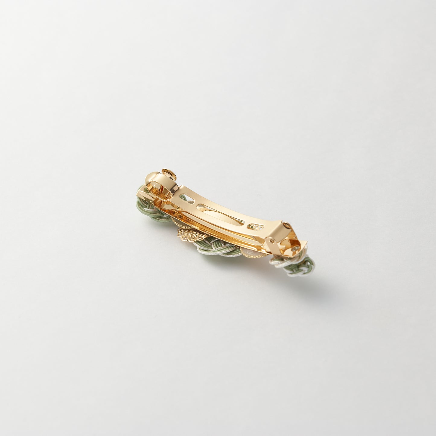 Reverse side of handmade Japanese hair accessory in green, showing clasp detail