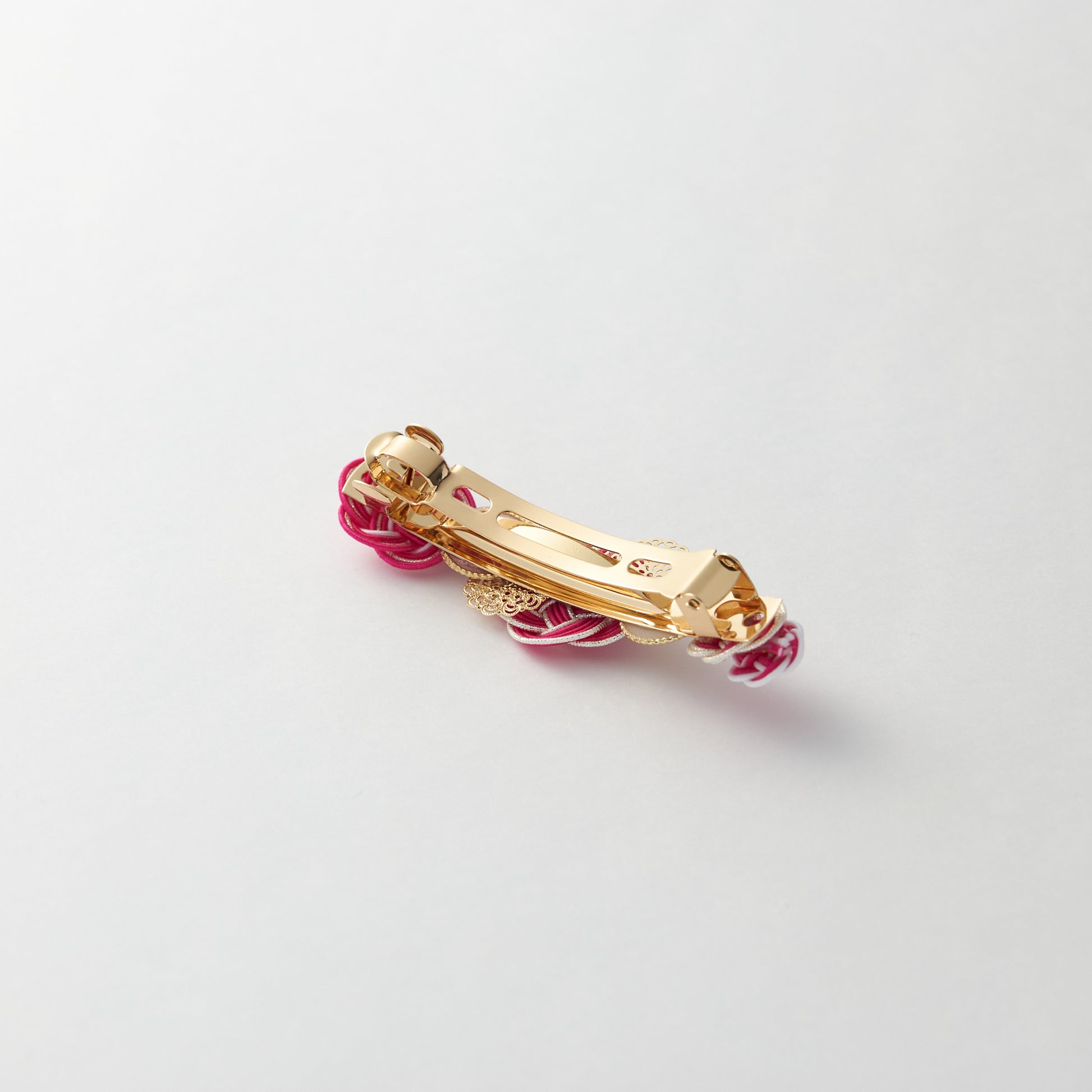 Reverse side of handmade Japanese hair accessory in pink, showing clasp detail