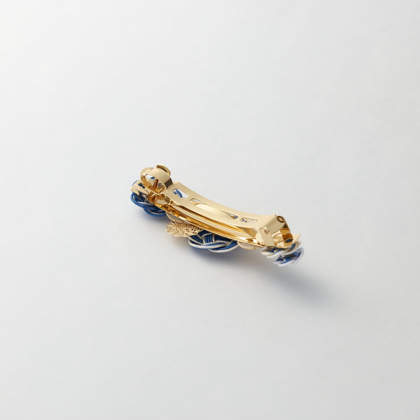 Reverse side of handmade Japanese hair accessory in blue, showing clasp detail