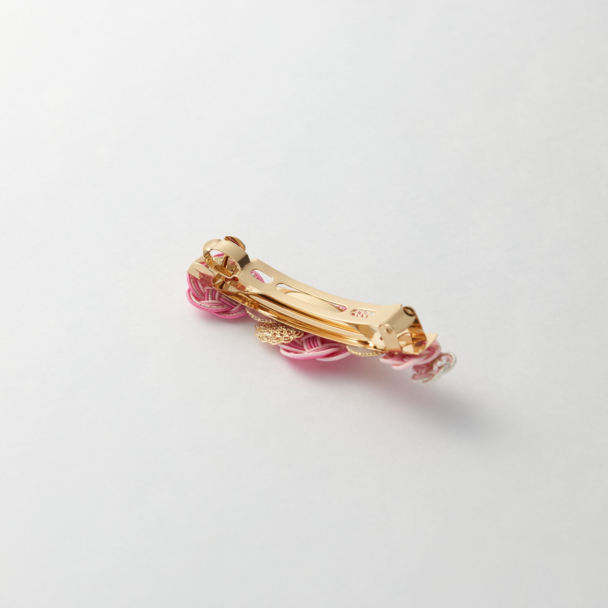 Reverse side of handmade Japanese hair accessory in light pink, showing clasp detail