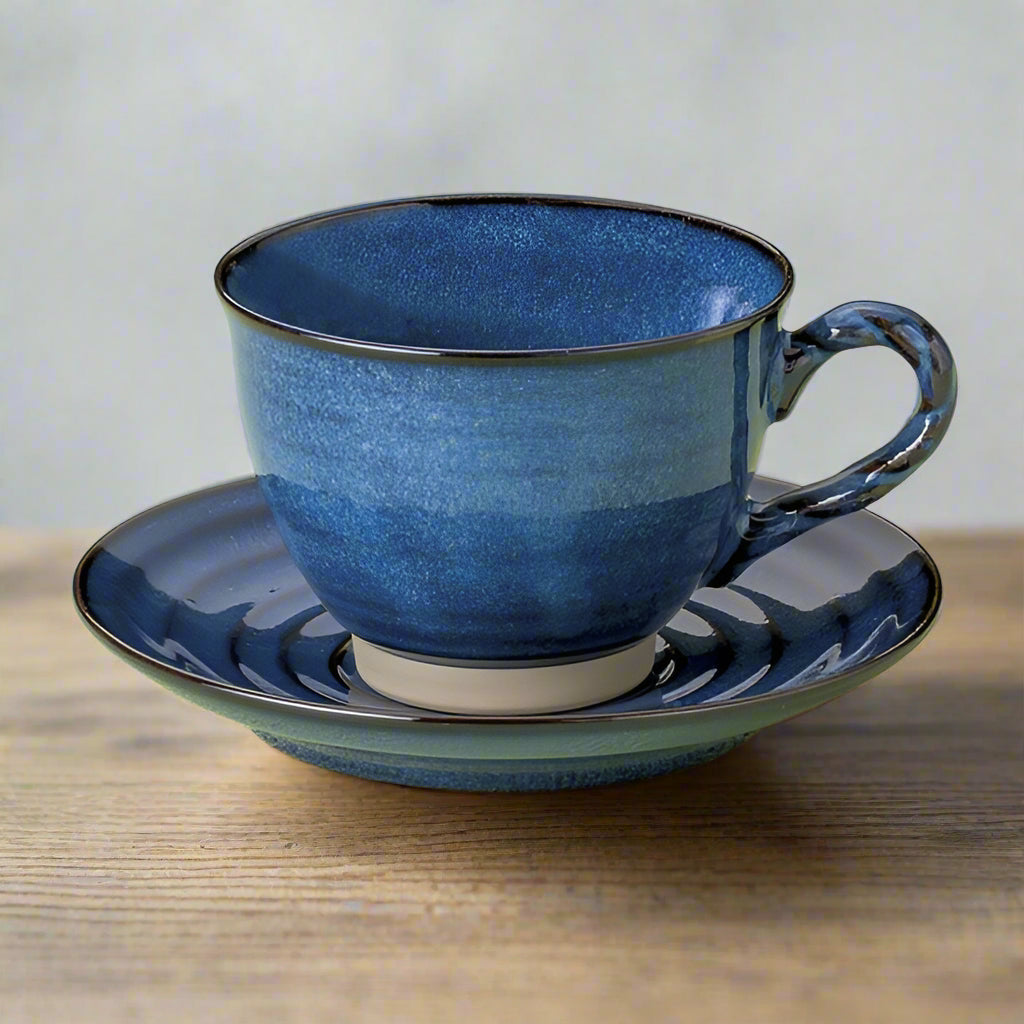 Coffee cup and saucer set with deep blue Namako glaze and natural ceramic base, featuring twisted Nawate-style handle