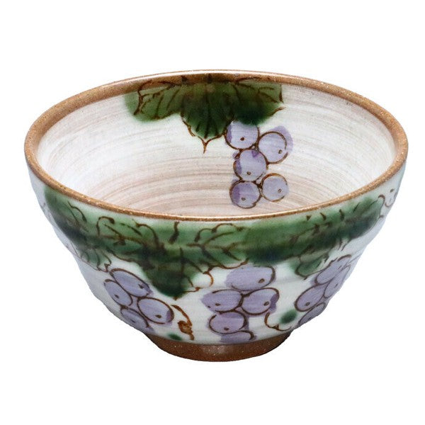 Handcrafted Minoware bowl with grape motif, painted in soft colors on warm ceramic surface