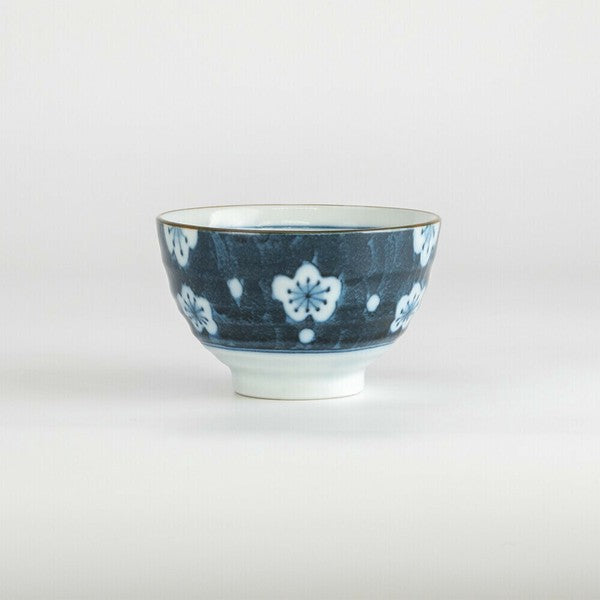Side angle showing delicate blue floral pattern on porcelain teacup