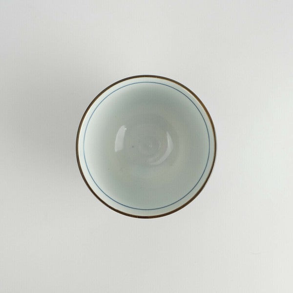 Top view of Japanese Mino Ware porcelain sencha cup with floral interior design