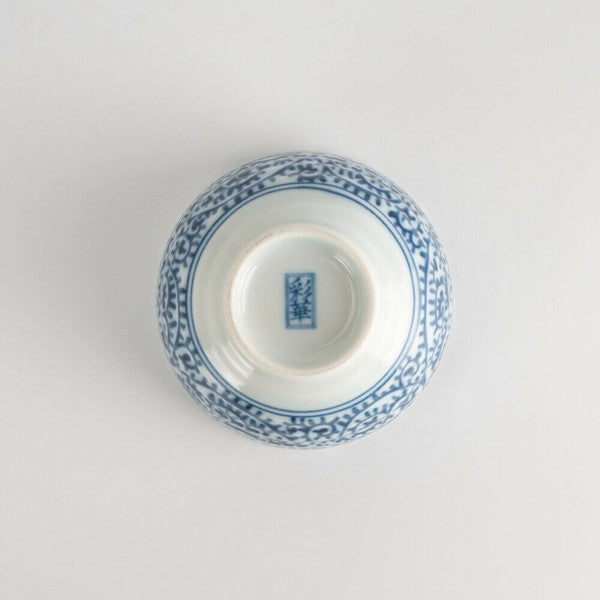 Bottom view of indigo-patterned porcelain teacup with unglazed foot and kiln mark