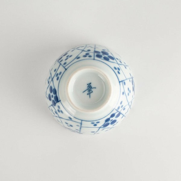 Bottom view of plum blossom patterned porcelain teacup with unglazed foot and kiln mark