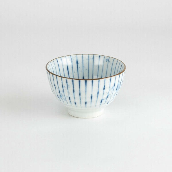 Front view of Mino Ware porcelain sencha teacup with hand-painted vertical indigo lines and brown rim
