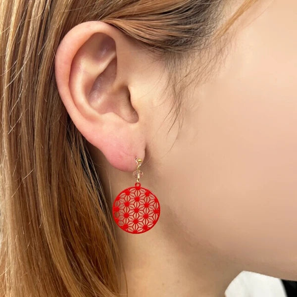 Model wearing red hemp leaf earrings in lightweight resin