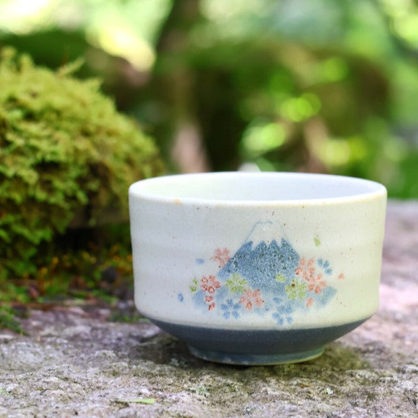 Mino ware matcha bowl in Fuji Sakura design, displayed outdoors