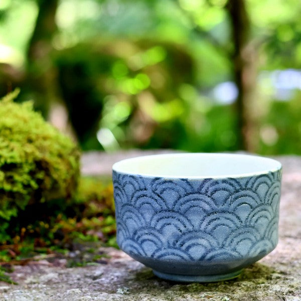 Mino ware matcha bowl in Seigaiha Waves design, displayed outdoors