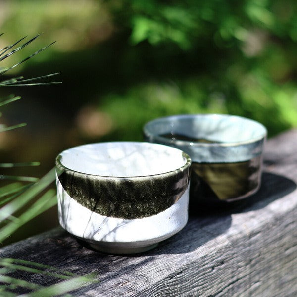 Mino ware matcha bowl in Flowing Mist and Oribe designs, displayed outdoors