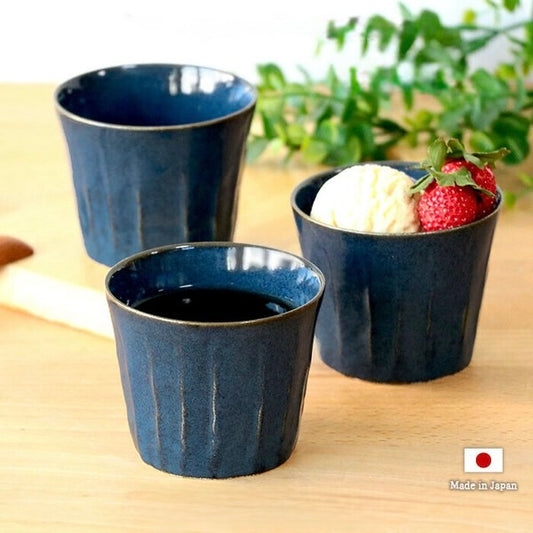 Ceramic cup used as a dessert bowl, holding ice cream and strawberries, showcasing its versatile use with made in Japan logo.