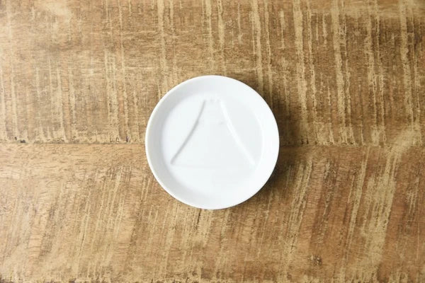 White porcelain dipping plate with sauce revealing a Mount Fuji design, Japanese made mini plate