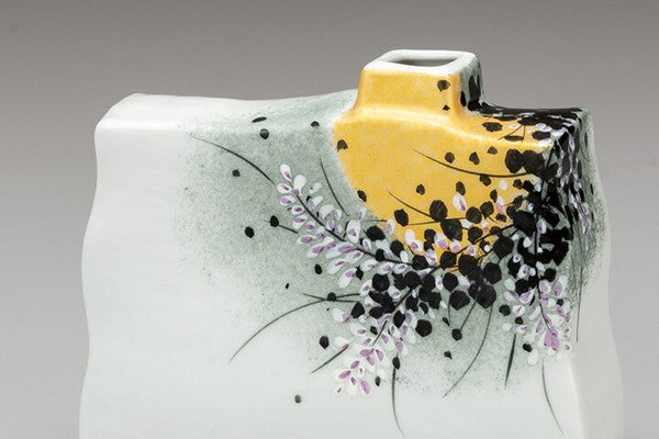 Detail of Kutani ware vase featuring gold accents and delicate floral decoration
